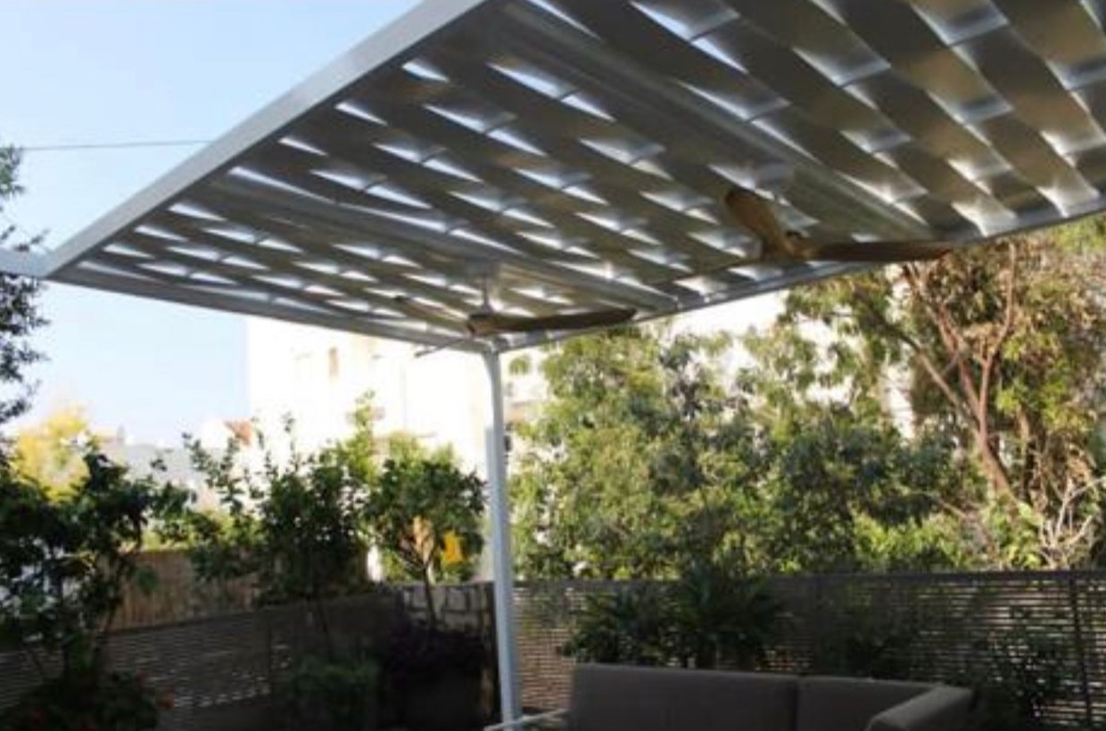 Louvered aluminum pergola over a backyard lounge